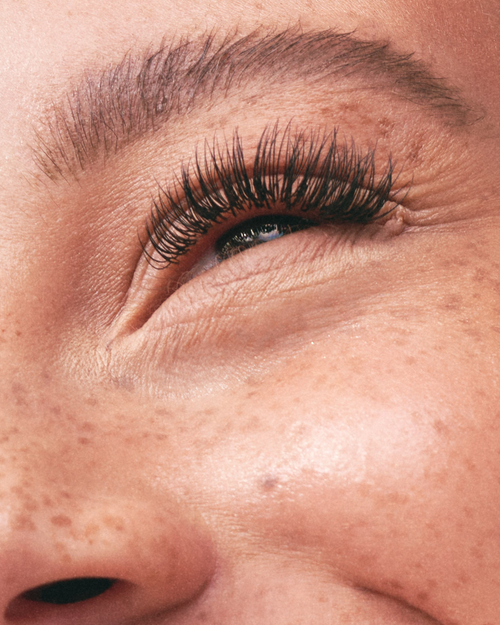 A model's eye with eyelash extensions applied.