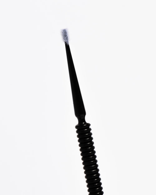 Close up of Micro Brush wand for lash extensions and brow services.