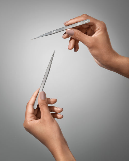 A model holding I-S Eyelash Extensions Isolation Tweezers.