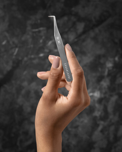A model holding a lash extension Volume Tweezer V-90.