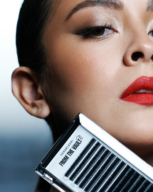 A model holding a tray of Lashes near her chin.